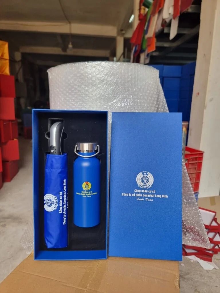 Bộ b&igrave;nh v&agrave; &ocirc; in dấu trong hộp xanh cạnh vật liệu bọc bảo vệ