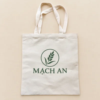 Demo MẠCH AN xanh lá với biểu tượng bông lúa trên túi canvas mộc